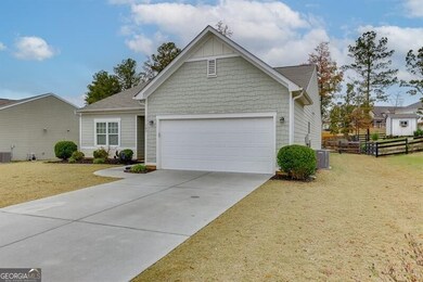 View of front of property with driveway, an attached garage, and roof with shingles