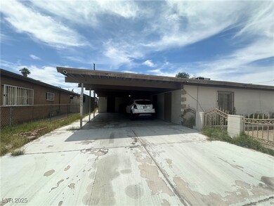 View of car parking featuring driveway and a carpo