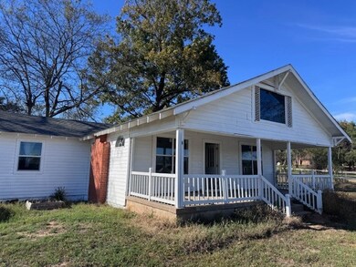 View of front of house with a porch and a front yard