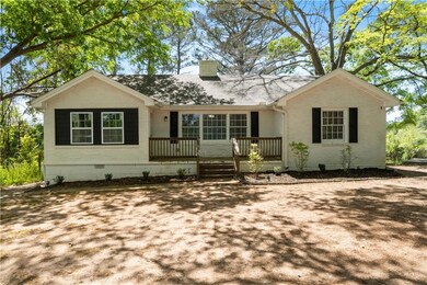 Single story home with brick siding, a shingled ro