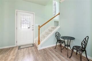 Foyer featuring wood finished floors, plenty of n