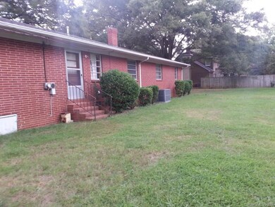 Back of home - several outbuildings and large utility room.