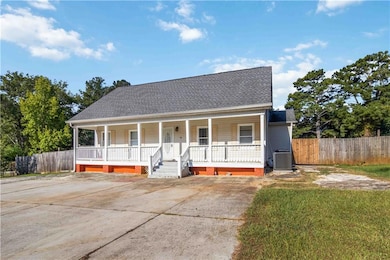 View of front of home with a shingled roof and covered porch