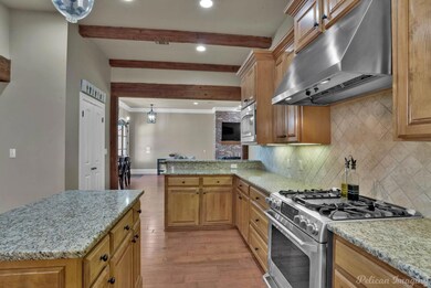 Kitchen featuring gas range, light wood finished f