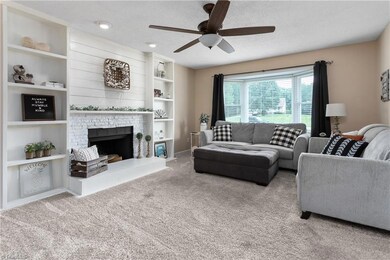 Cute and welcoming den, accented with shiplap, built-ins and fireplace.