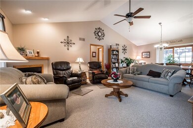 Living room with cathedral ceiling and corner fire