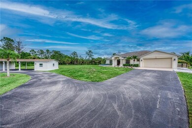 Ranch-style house with a carport, a garage, and a 
