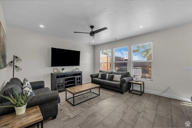 Living area featuring ceiling fan, recessed lighting, a textured ceiling, and wood finish floors