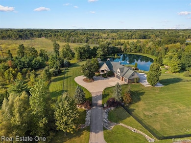 Aerial view of property and surrounding area with a heavily wooded area and a large body of water
