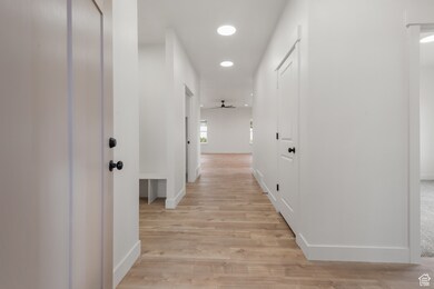 Corridor featuring recessed lighting and light wood-style floors