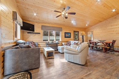 Living room featuring ceiling fan, hardwood / wood