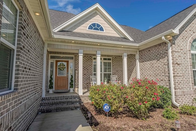 Entrance to property with brick siding and a shingled roof
