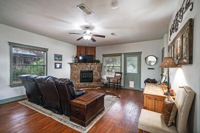 Living room with dark wood-type flooring, ceiling 