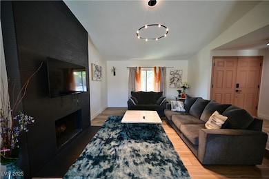 Living area with a chandelier, wood finished floor