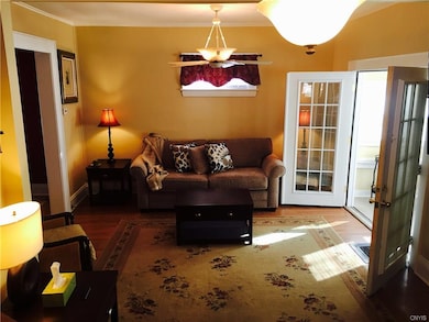 French doors from enclosed porch lead you into nic