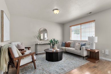 Living room with hardwood / wood-style flooring and a textured ceiling
