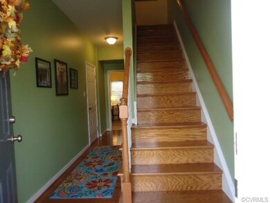 Foyer with oak floors and oak stairway to Level 2.