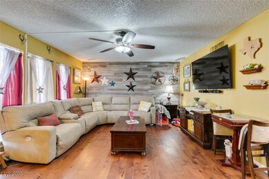 Living area featuring wood finished floors, an acc