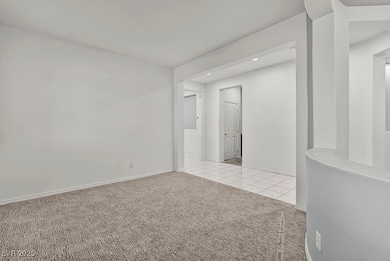 Formal living room featuring light colored carpet, light tile patterned flooring, and recessed lighting, at the entry
