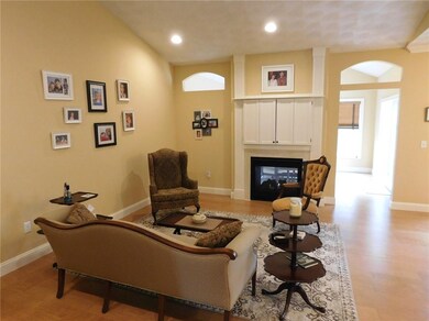 Living room with double fireplace and cathedral ce