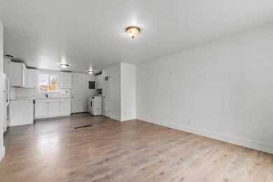 Unfurnished living room with light wood-style flooring and washer and clothes dryer