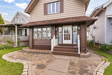 Entrance to property with roof with shingles
