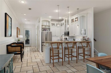 Kitchen with ornamental molding, open shelves, glass insert cabinets, stainless steel appliances, and white cabinets