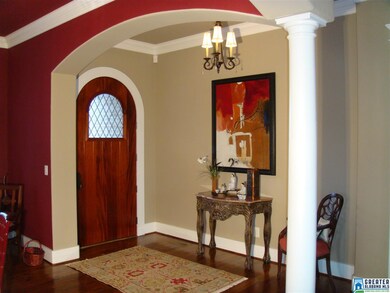 Entering through an arch front door with leaded gl