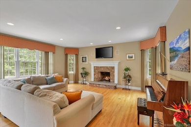 Large family room, looks over pool. Fireplace, hardwood floors, custom window treatments