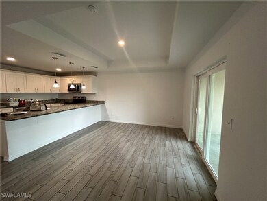 Kitchen with stainless steel appliances, a raised