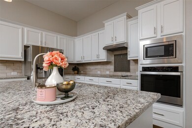 Kitchen with stainless steel appliances, white cab