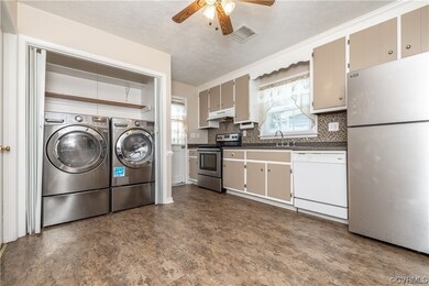 Laundry area featuring natural light and washer /