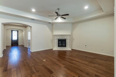Unfurnished living room featuring a raised ceiling