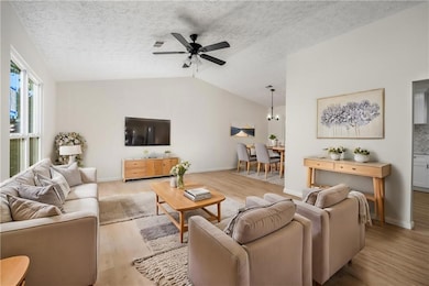 Living room with a ceiling fan, wood finished floo
