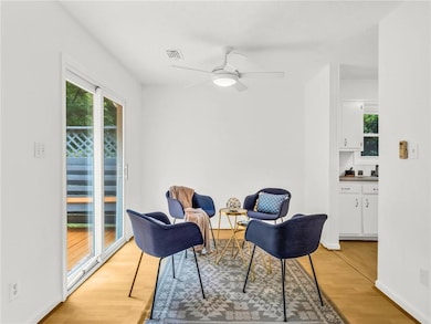 Living area with a high ceiling, ceiling fan, wood