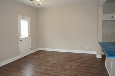 First Half of the Great Room.  LVP Flooring all on the first floor.  Door on the left goes out to the back Patio.