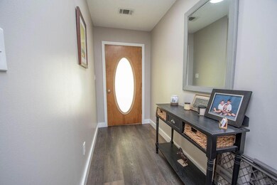 Entryway featuring baseboards and wood finished floors