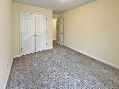 Unfurnished bedroom featuring carpet floors, a closet, and a textured ceiling