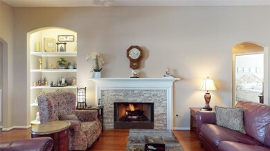 This lovely stacked stone fireplace is featured here and will warm your friends and family when it's cold outside!
The front bedroom can be seen in the right of the picture and the lighted shelves are next to the doorway into the primary bedroom.