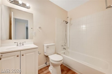 Bathroom with wood finished floors, vanity, and ba