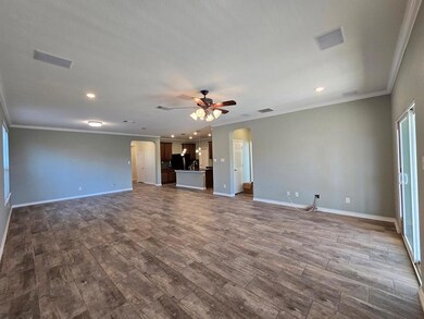 Unfurnished living room featuring dark wood-style
