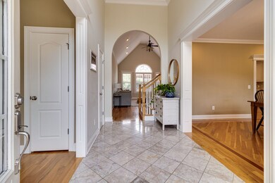 The entryway boasts oversized custom molding and arch
