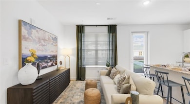 Living room featuring hardwood / wood-style floors and plenty of natural light