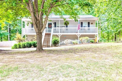 View of front of property with stairs and covered porch