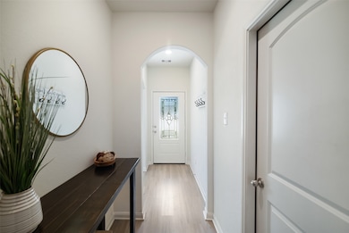 The light and bright foyer is beautifully accented