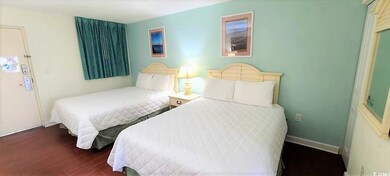 Bedroom featuring baseboards and wood finished floors