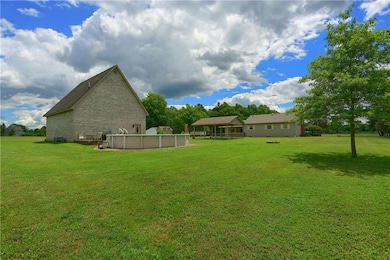 back yard view of pool, garage, pavilion and house