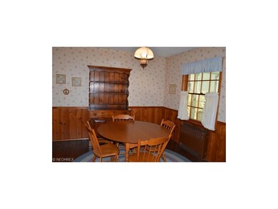 Eating area of kitchen with wood floors.