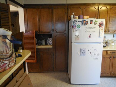 Kitchen featuring white refrigerator