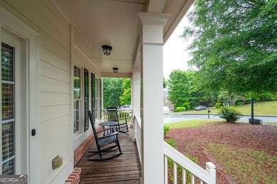 Cozy front porch with space for rocking chairs - perfect for relaxing.